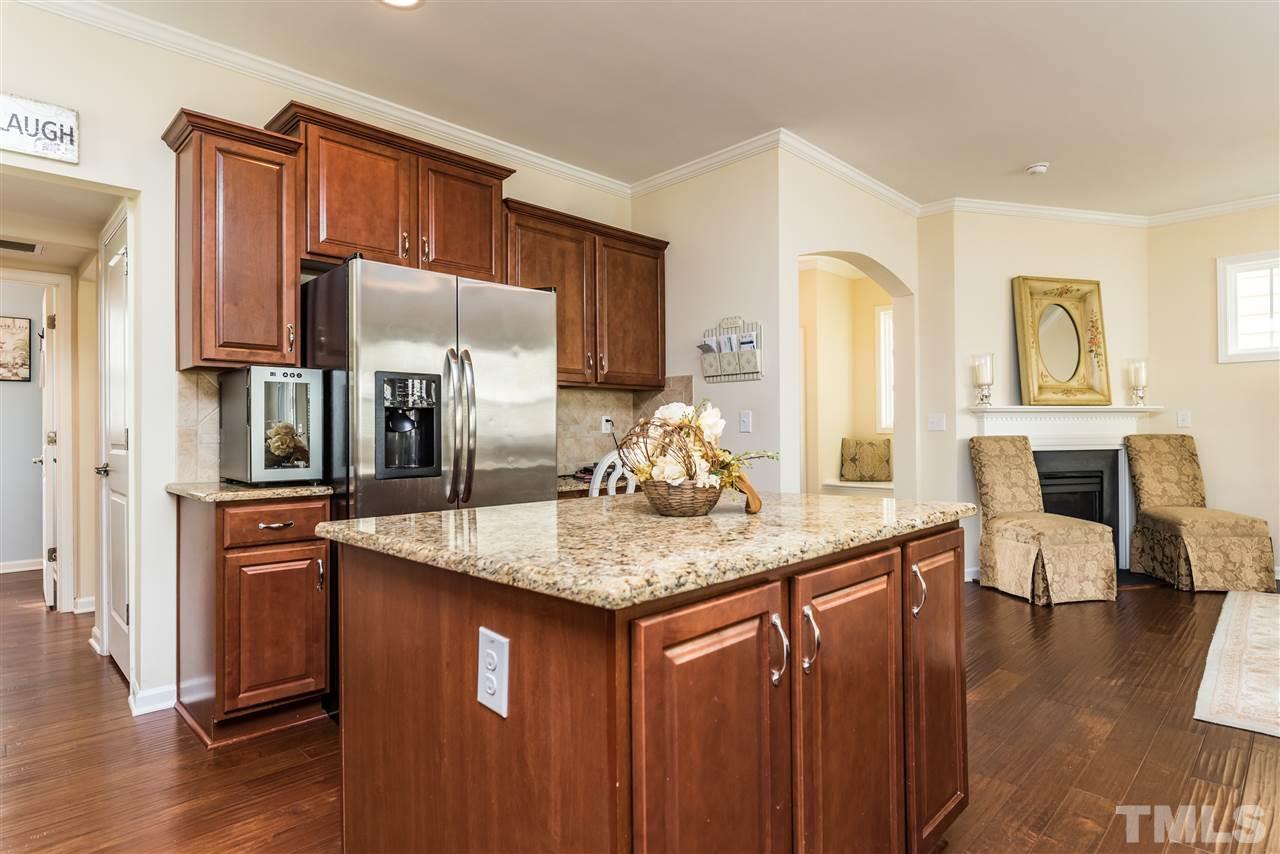 1413 Van Page Boulevard Raleigh, NC 27607 - Photo 9 of 25 a kitchen with stainless steel appliances granite countertop a sink a stove and refrigerator