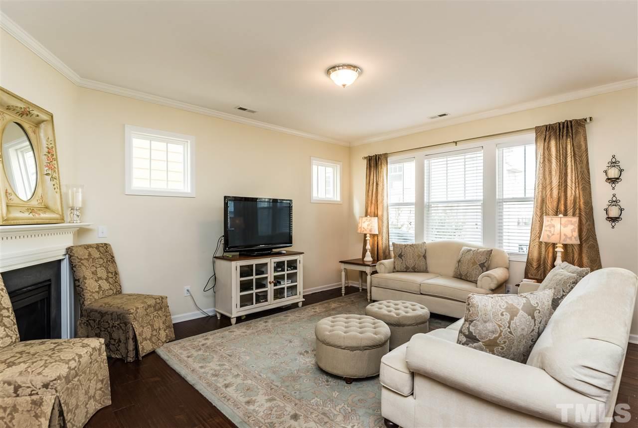 1413 Van Page Boulevard Raleigh, NC 27607 - Photo 10 of 25 a living room with furniture and a flat screen tv