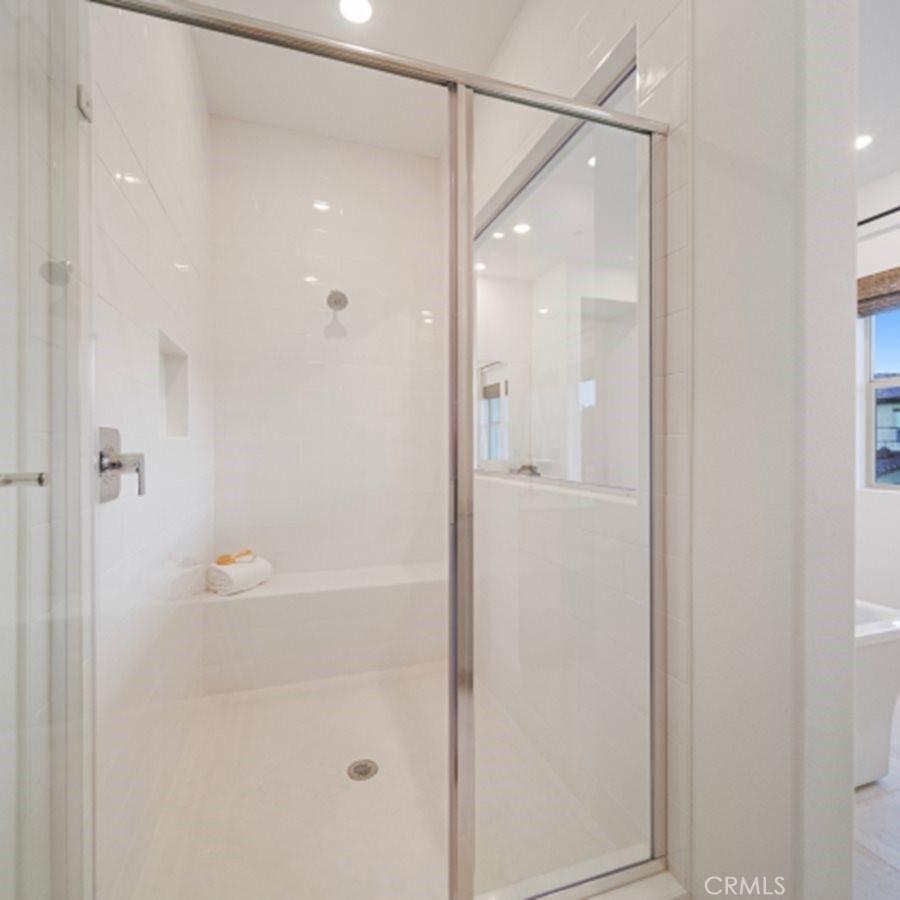 29809 Corte Trono Valencia, CA 91354 - Photo 16 of 36 a bathroom with a glass shower door