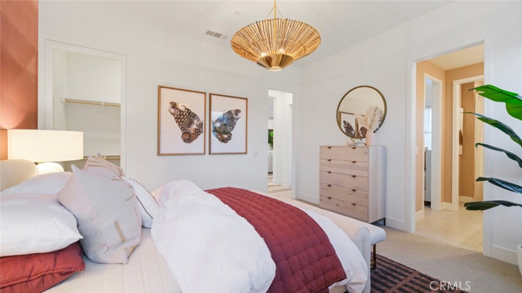 29809 Corte Trono Valencia, CA 91354 - Photo 19 of 36 a bedroom with a bed and a chandelier