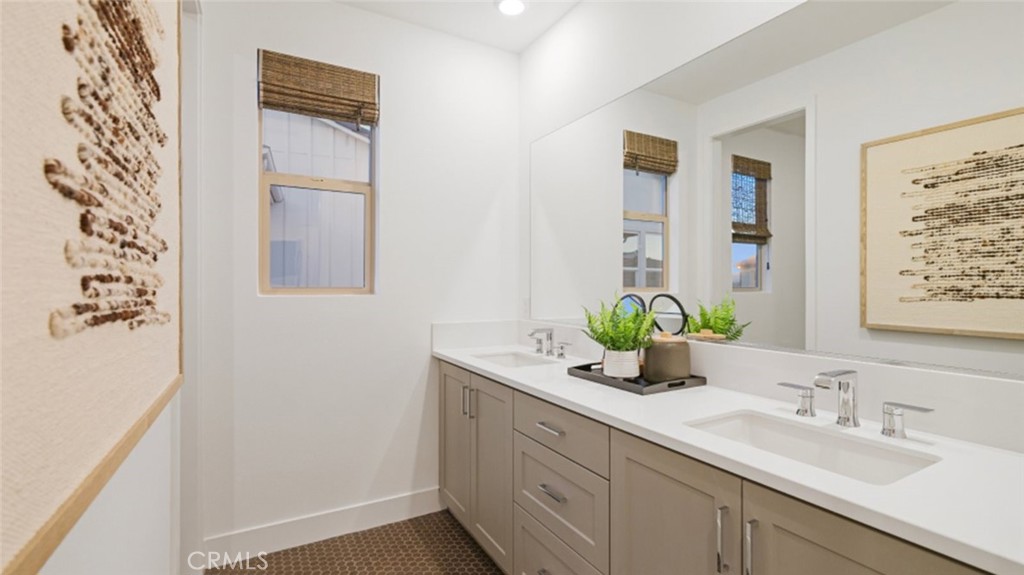 29809 Corte Trono Valencia, CA 91354 - Photo 23 of 36 a bathroom with a granite countertop sink a mirror and vanity