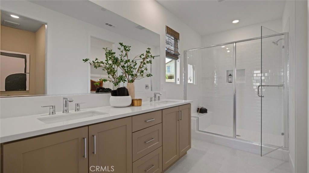 29809 Corte Trono Valencia, CA 91354 - Photo 26 of 36 a bathroom with a shower sink and mirror
