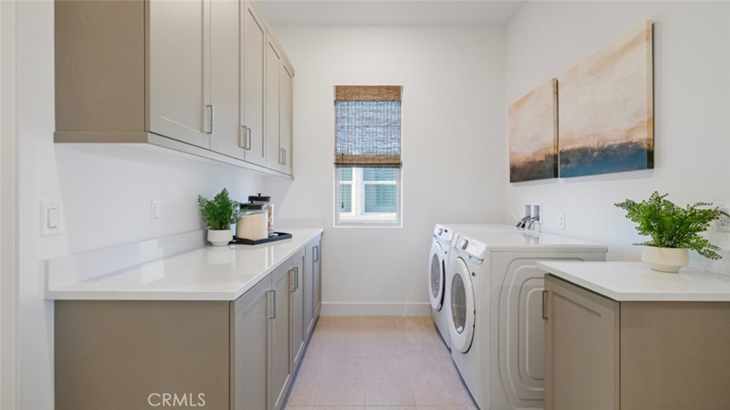 29809 Corte Trono Valencia, CA 91354 - Photo 30 of 36 a utility room with cabinets washer and dryer