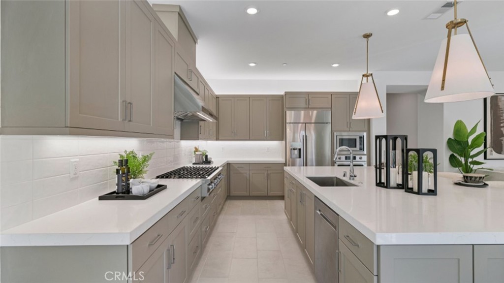 29809 Corte Trono Valencia, CA 91354 - Photo 3 of 36 a kitchen with kitchen island white cabinets and white appliances