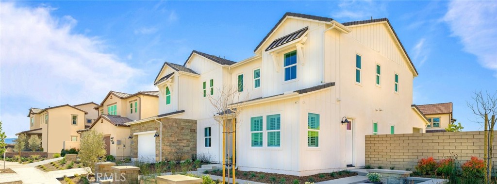 29809 Corte Trono Valencia, CA 91354 - Photo 32 of 36 a view of a blue house with a yard and windows