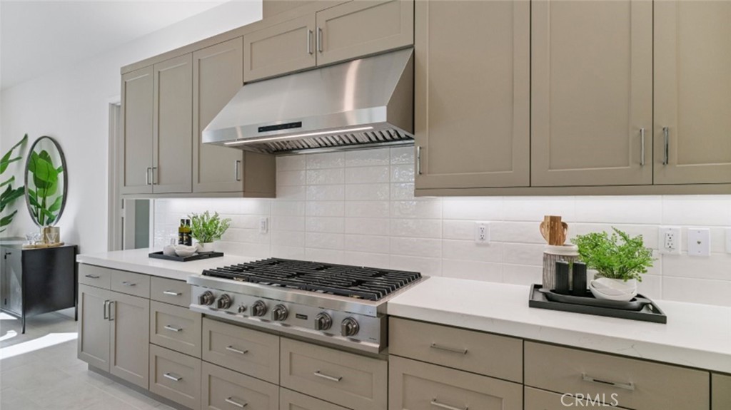 29809 Corte Trono Valencia, CA 91354 - Photo 4 of 36 a kitchen with stainless steel appliances a stove a white cabinets and a potted plant