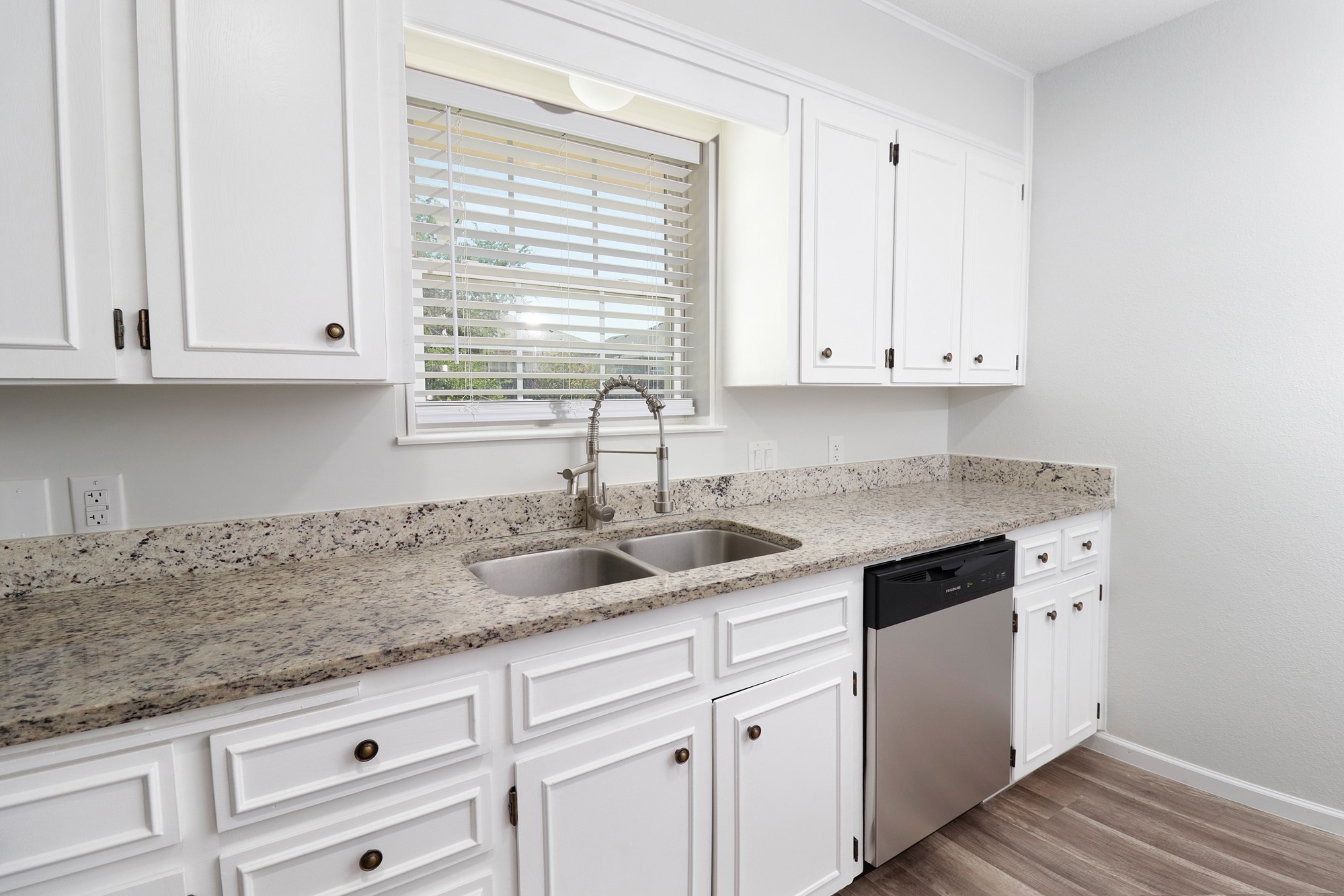 2510 Bunker Hill Drive Temple, TX 76504 - Photo 11 of 30 a kitchen with granite countertop white cabinets and a window