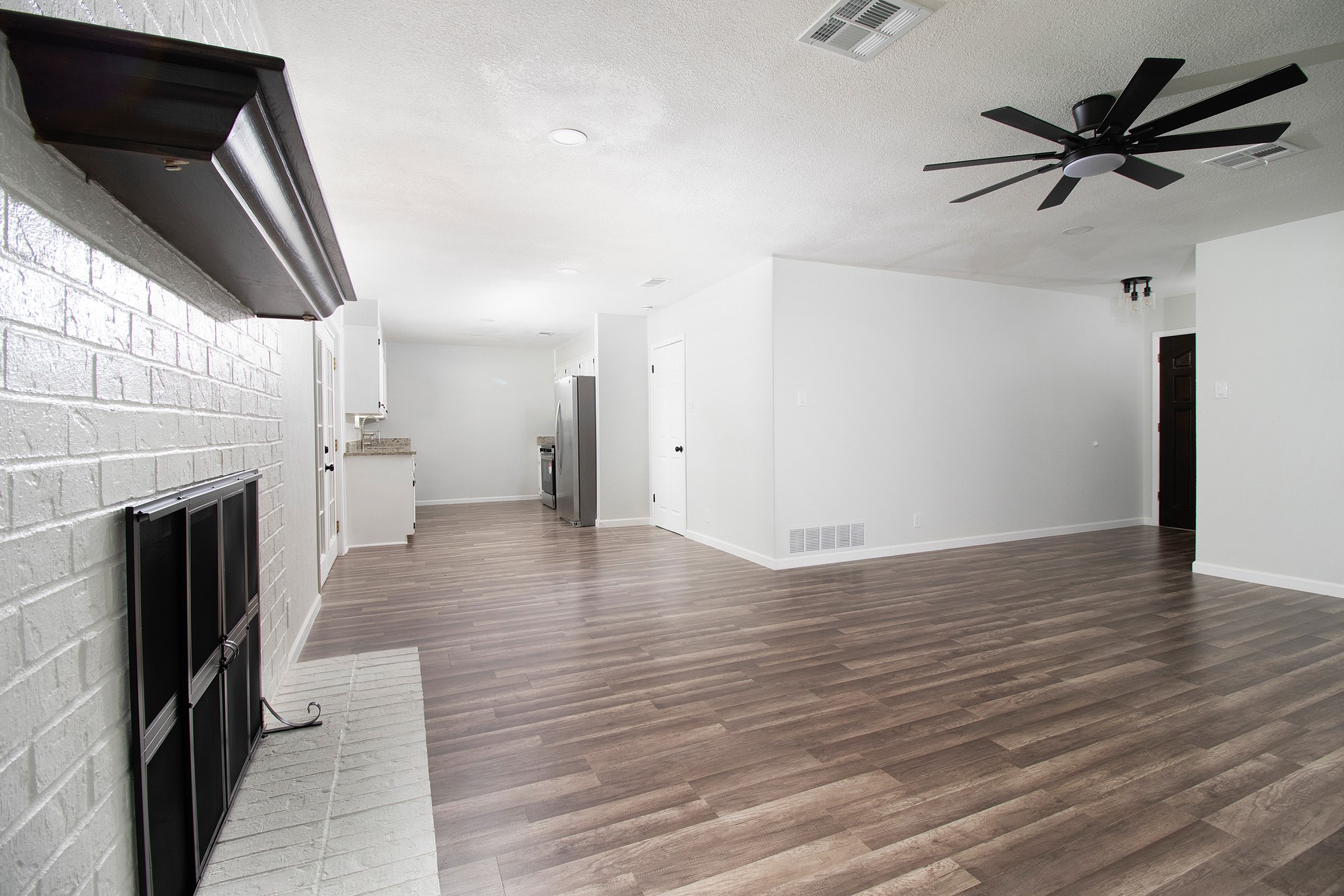 2510 Bunker Hill Drive Temple, TX 76504 - Photo 8 of 30 wooden floor in an empty room with a fireplace