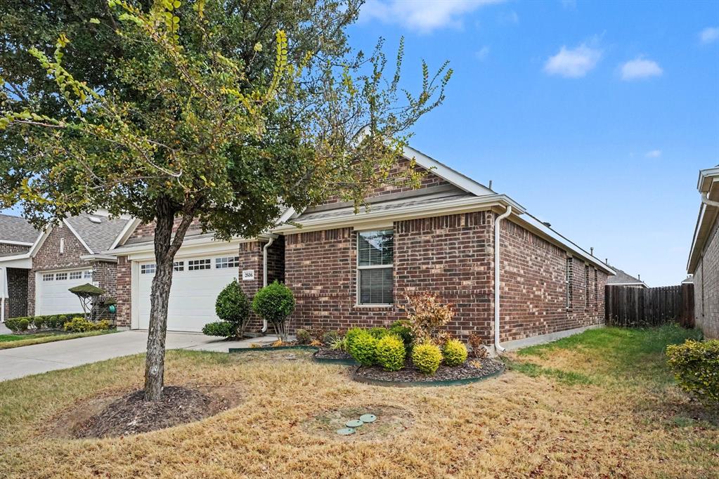 2606 Middleton Road Glenn Heights, TX 75154 - Photo 5 of 18 Brick exterior with white garage doors and a paved driveway