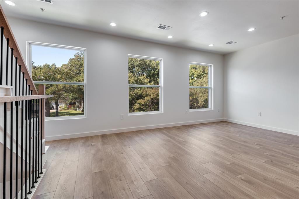 516 South O Connor Road Irving, TX 75060 - Photo 14 of 40 an empty room with wooden floor and windows