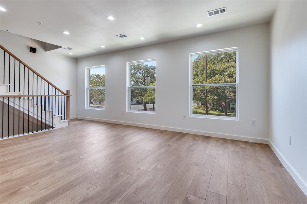 516 South O Connor Road Irving, TX 75060 - Photo 16 of 40 an empty room with wooden floor and windows