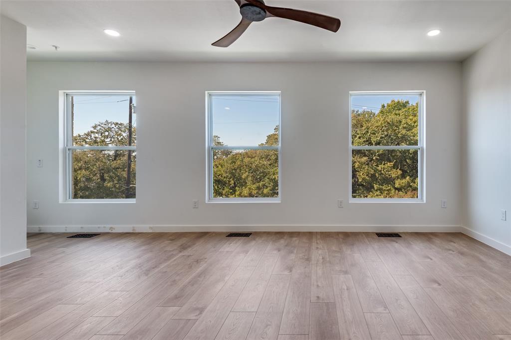 516 South O Connor Road Irving, TX 75060 - Photo 18 of 40 an empty room with wooden floor and windows