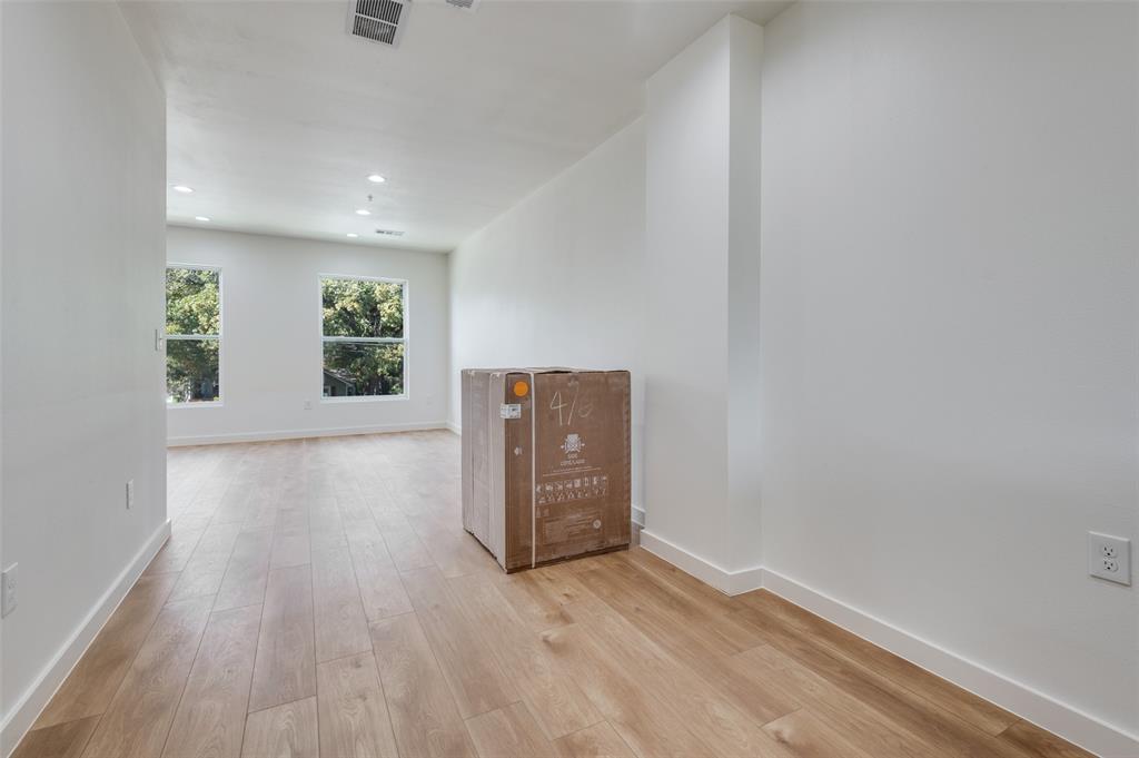 516 South O Connor Road Irving, TX 75060 - Photo 27 of 40 an empty room with wooden floor and windows