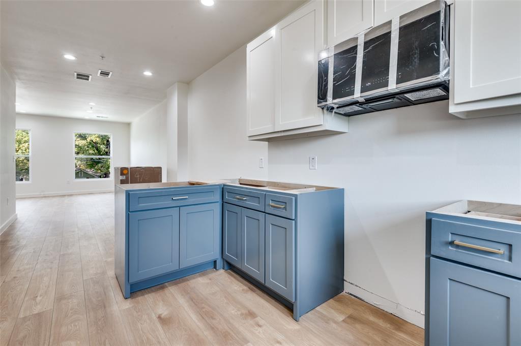 516 South O Connor Road Irving, TX 75060 - Photo 30 of 40 a kitchen with stainless steel appliances granite countertop a stove a microwave and a sink
