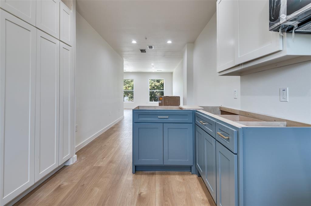 516 South O Connor Road Irving, TX 75060 - Photo 31 of 40 a kitchen with a sink cabinets and wooden floor