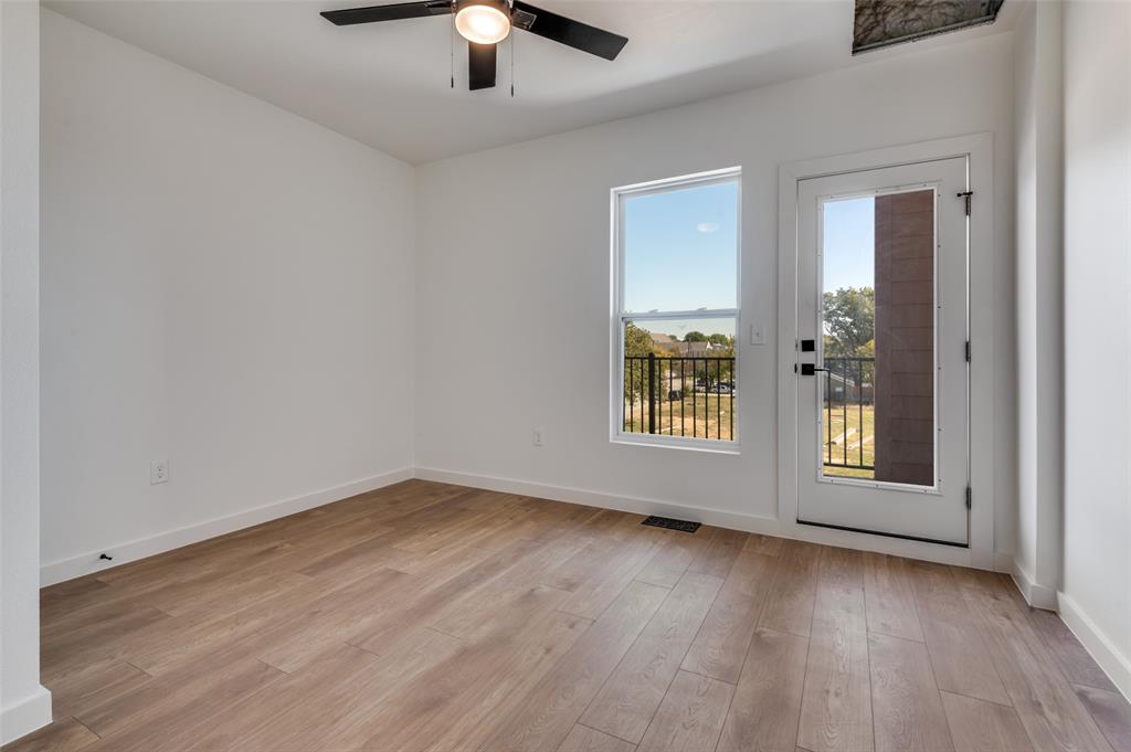 516 South O Connor Road Irving, TX 75060 - Photo 33 of 40 an empty room with wooden floor chandelier fan and windows