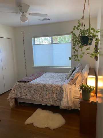 a bedroom with a bed and a window