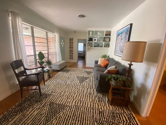 a bedroom with furniture and a window