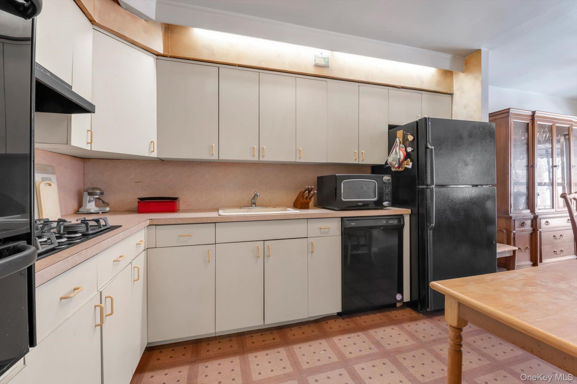 144-64 25th Road Queens, NY 11354 - Photo 11 of 21 a kitchen with a sink dishwasher a refrigerator and cabinets