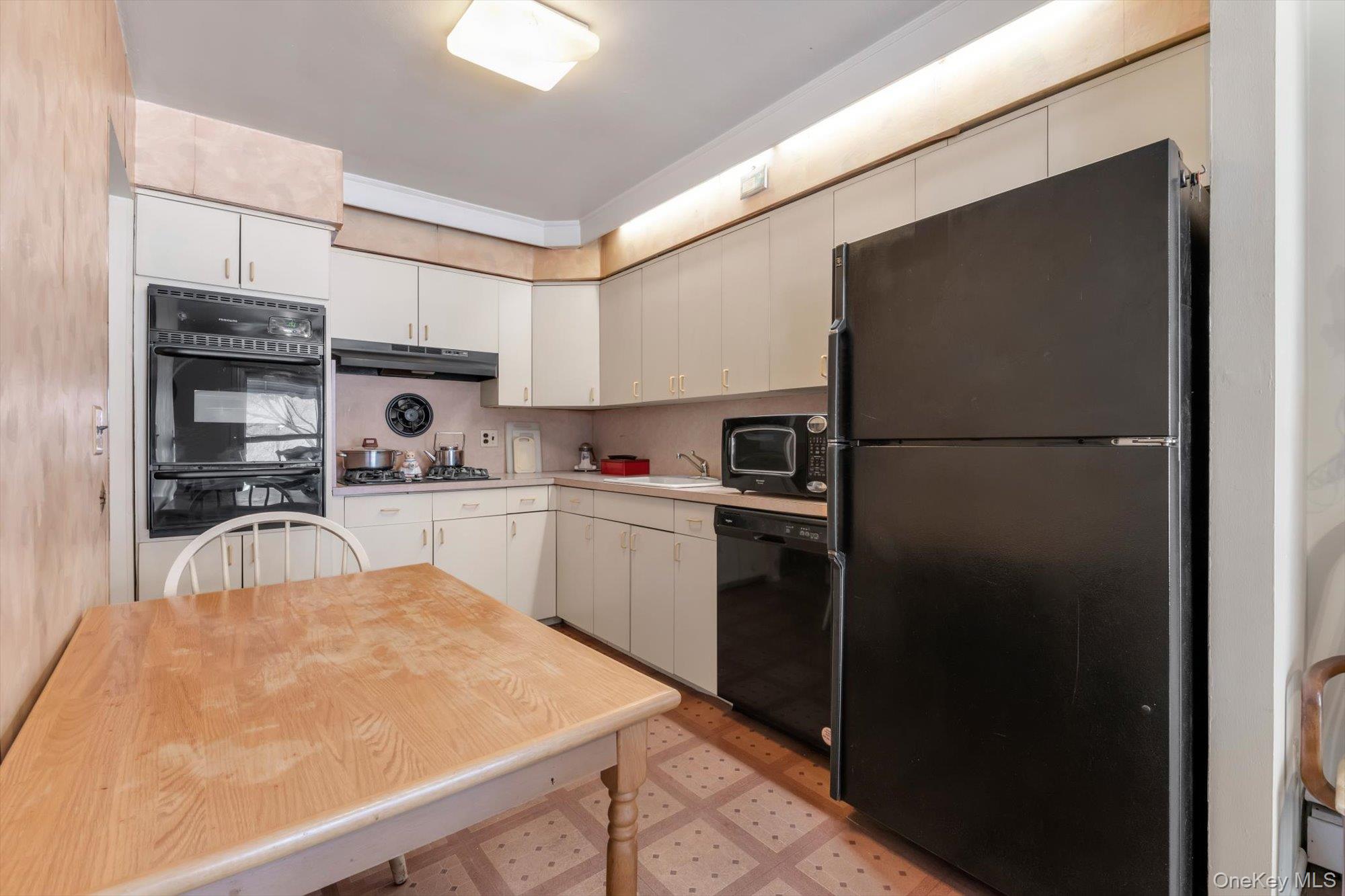 144-64 25th Road Queens, NY 11354 - Photo 13 of 21 a kitchen with kitchen island a counter top space cabinets and stainless steel appliances