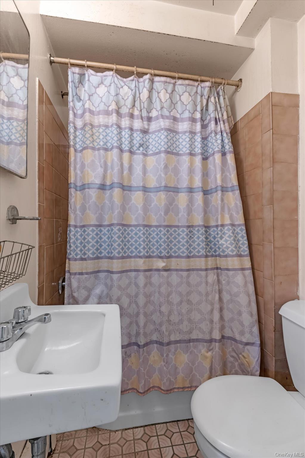 144-64 25th Road Queens, NY 11354 - Photo 20 of 21 a bathroom with a sink and a toilet