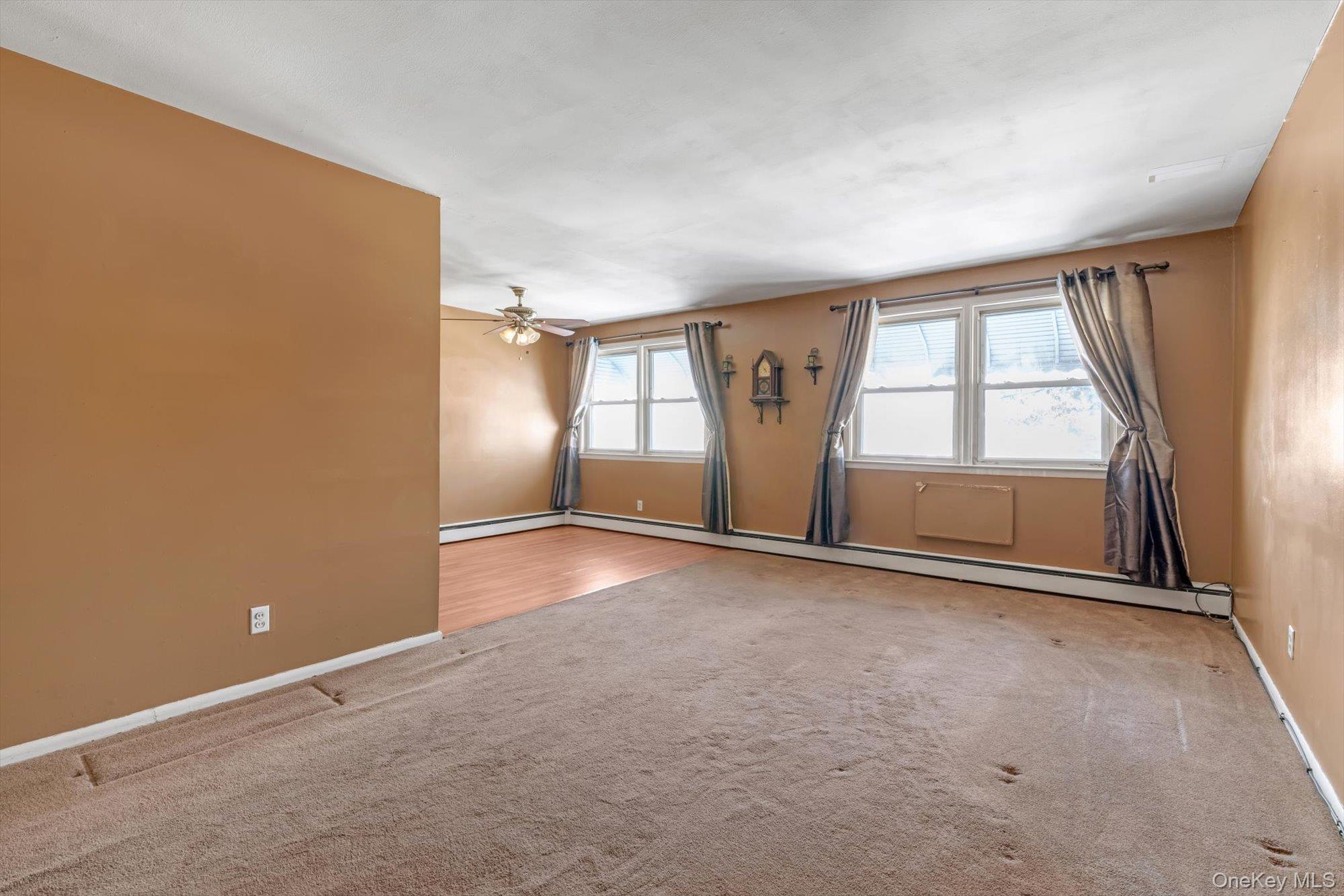 144-64 25th Road Queens, NY 11354 - Photo 2 of 21 an empty room with windows and closet