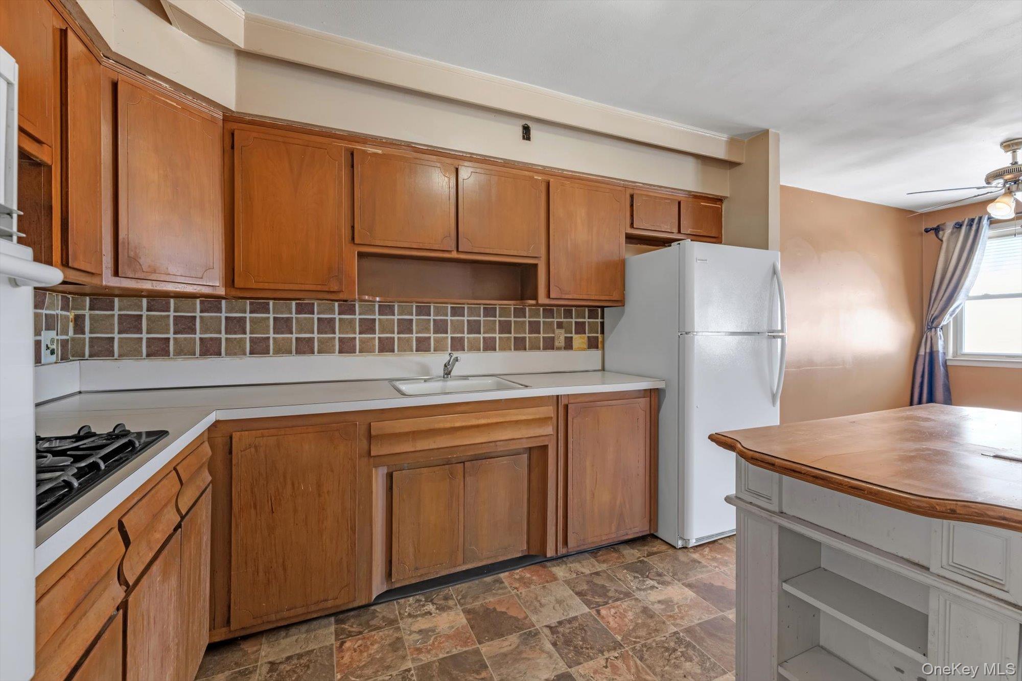 144-64 25th Road Queens, NY 11354 - Photo 4 of 21 a kitchen with stainless steel appliances granite countertop a refrigerator and a sink