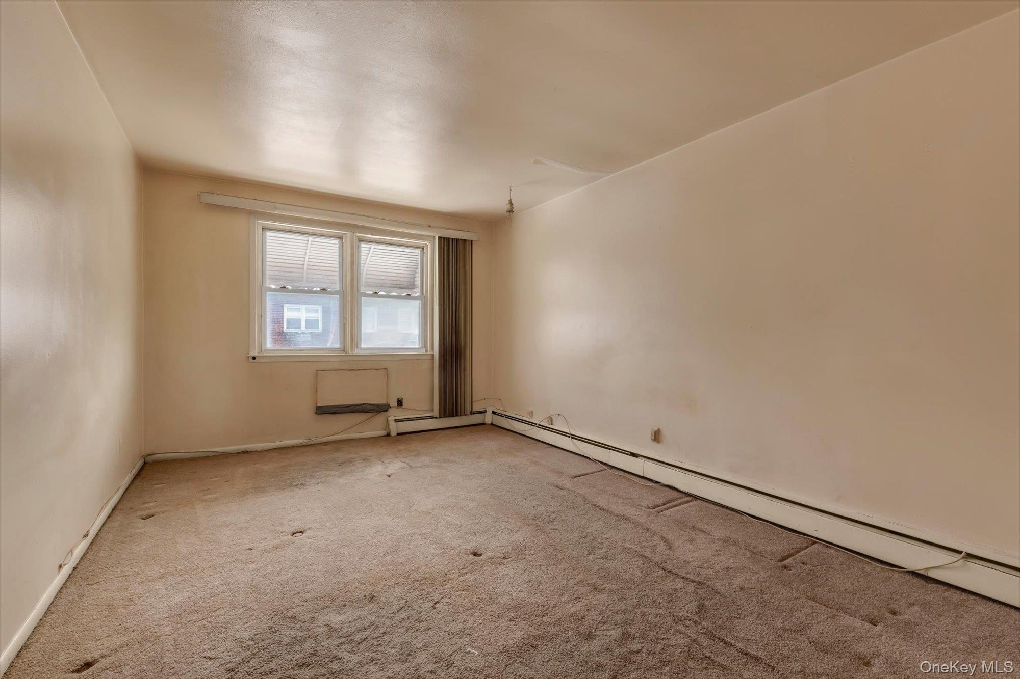 144-64 25th Road Queens, NY 11354 - Photo 6 of 21 an empty room with a windows