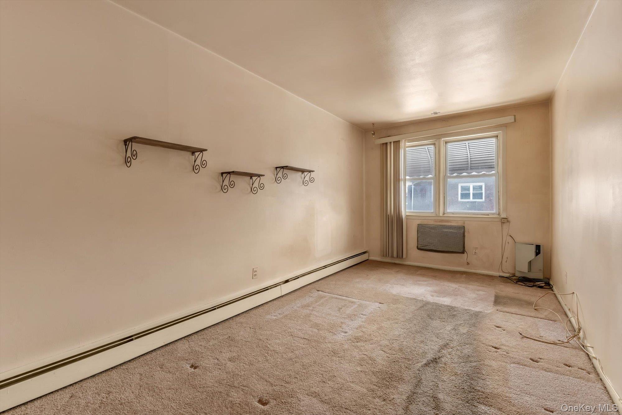 144-64 25th Road Queens, NY 11354 - Photo 7 of 21 a view of an empty room with a window