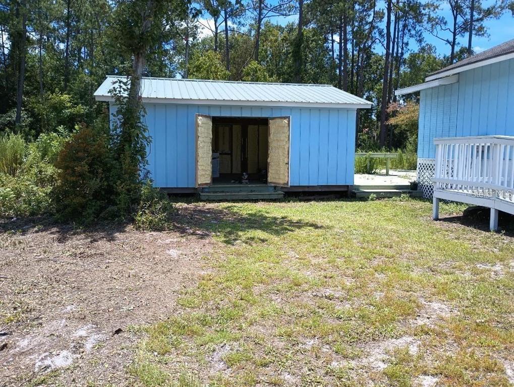 7230 Southwest 111th Terrace Cedar Key, FL 32625 - Photo 4 of 7 a view of a house with a yard and wooden fence