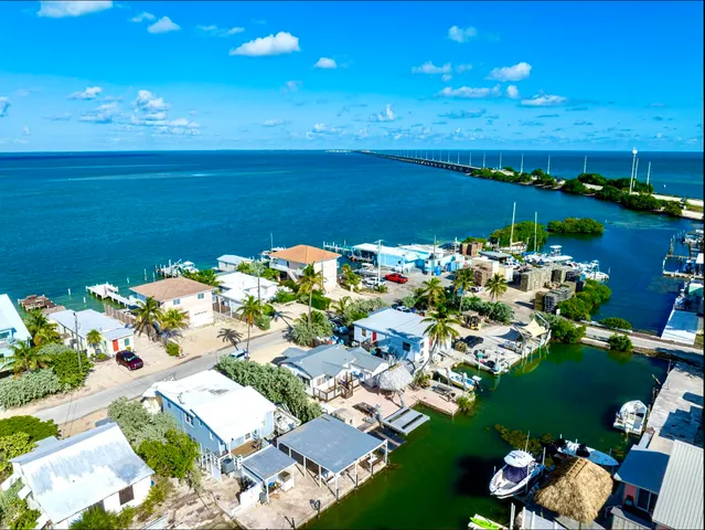 a dining room with furniture a large window and a chandelier
