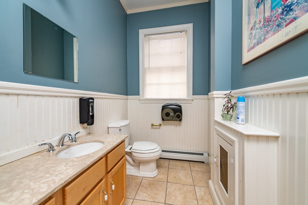 5 Phillips Place Cambridge, MA 02138 - Photo 4 of 8 a spacious bathroom with a granite countertop sink a toilet and a mirror