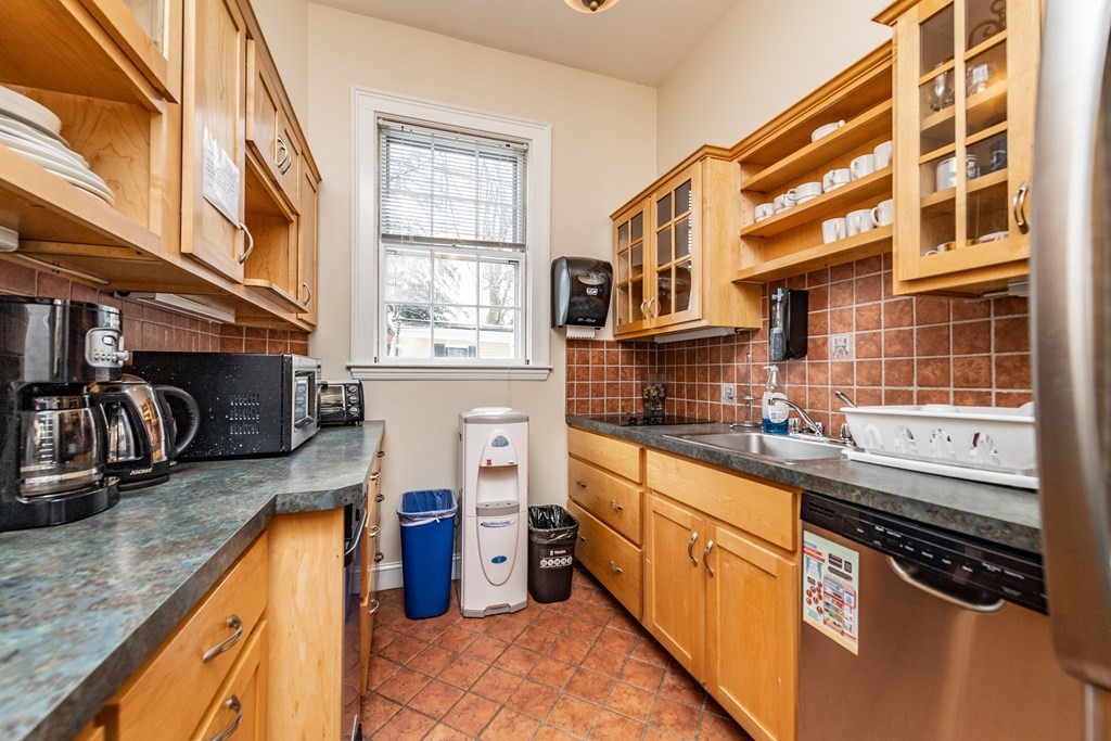 5 Phillips Place Cambridge, MA 02138 - Photo 5 of 8 a kitchen with stainless steel appliances granite countertop a sink and a stove