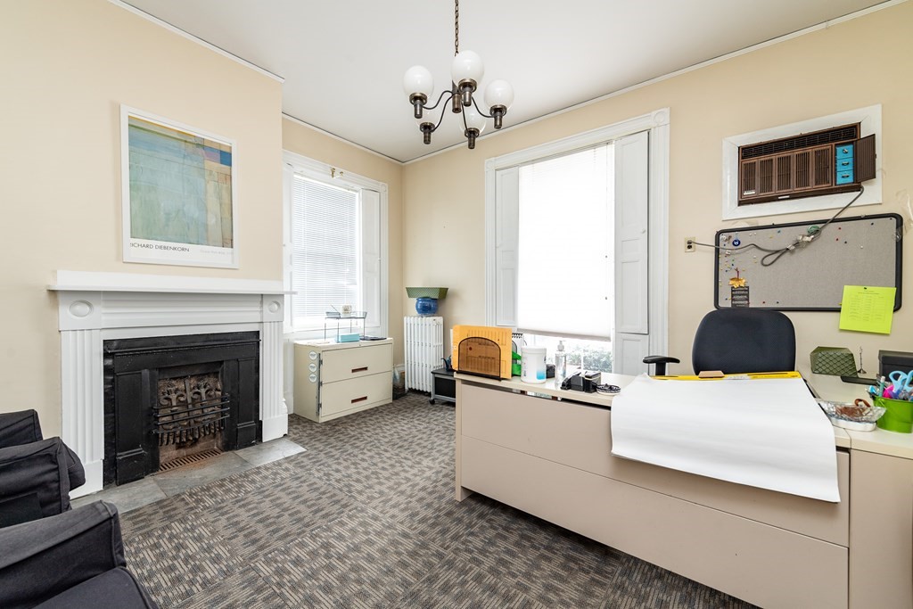 5 Phillips Place Cambridge, MA 02138 - Photo 6 of 8 a living room with furniture and a fireplace