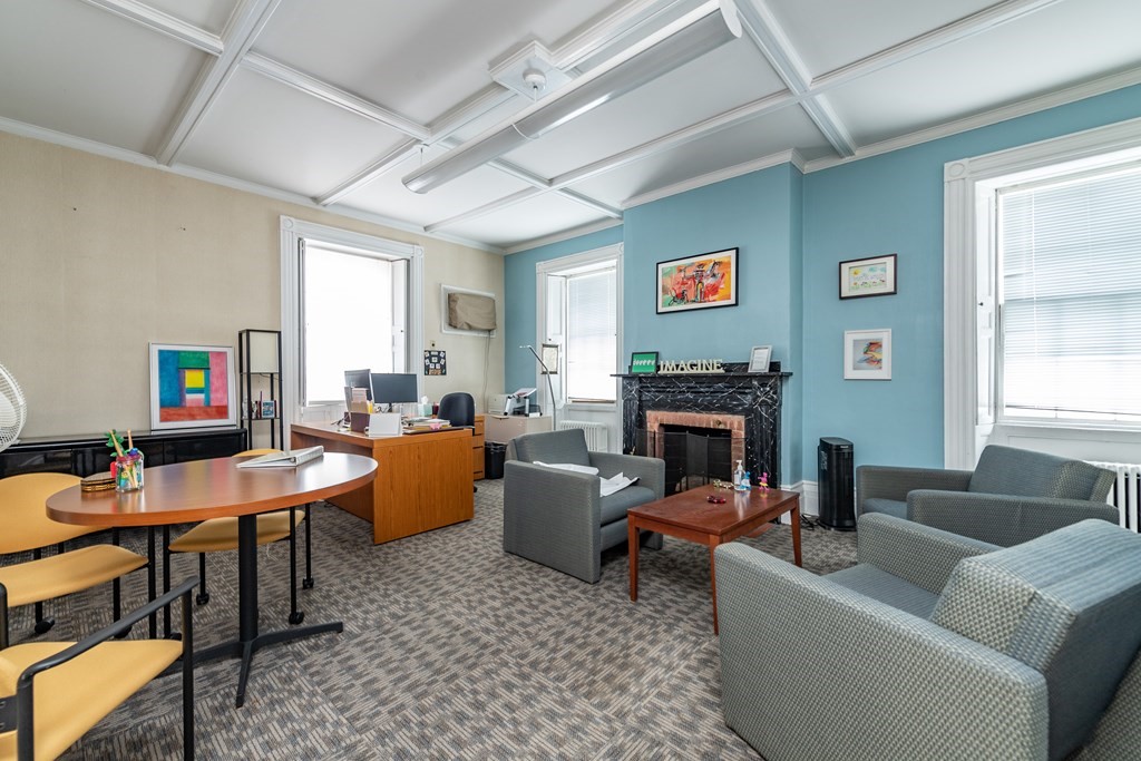 5 Phillips Place Cambridge, MA 02138 - Photo 7 of 8 a living room with furniture a fireplace and a window