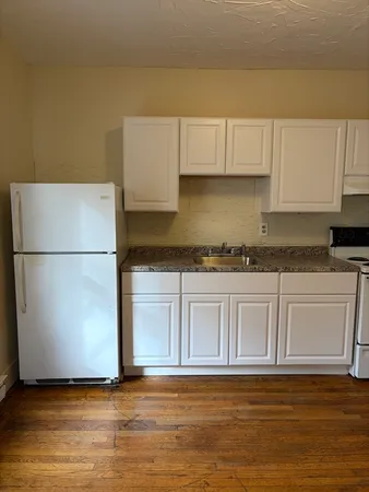 a view of a kitchen with granite countertop cabinets and a sink