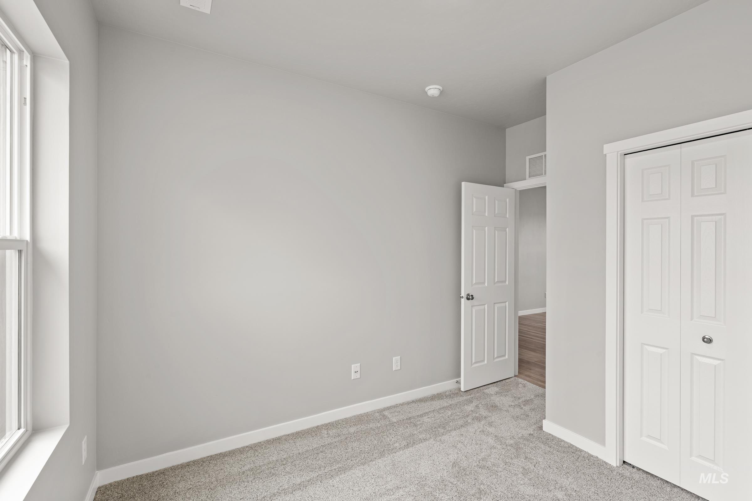 487 Hamlow Avenue Middleton, ID 83644 - Photo 18 of 19 Unfurnished bedroom featuring light colored carpet and a closet