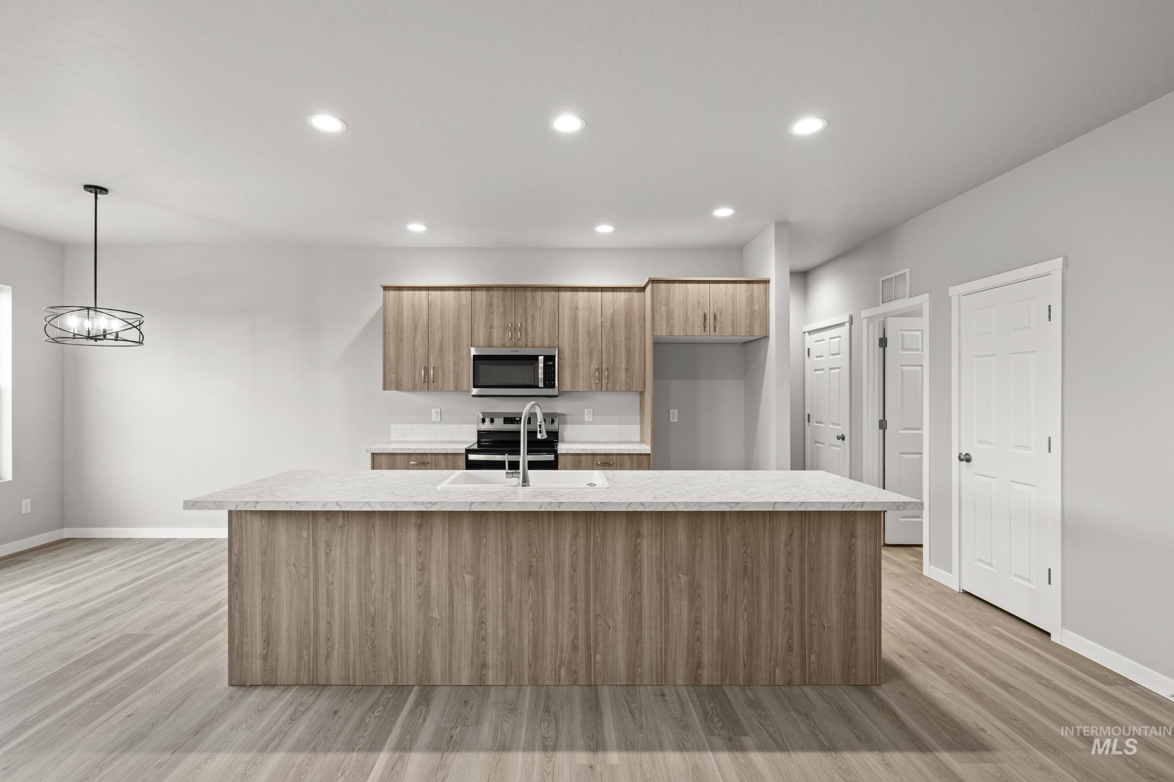 487 Hamlow Avenue Middleton, ID 83644 - Photo 3 of 19 Kitchen featuring stainless steel appliances, light wood-style flooring, an island with sink, and modern cabinets