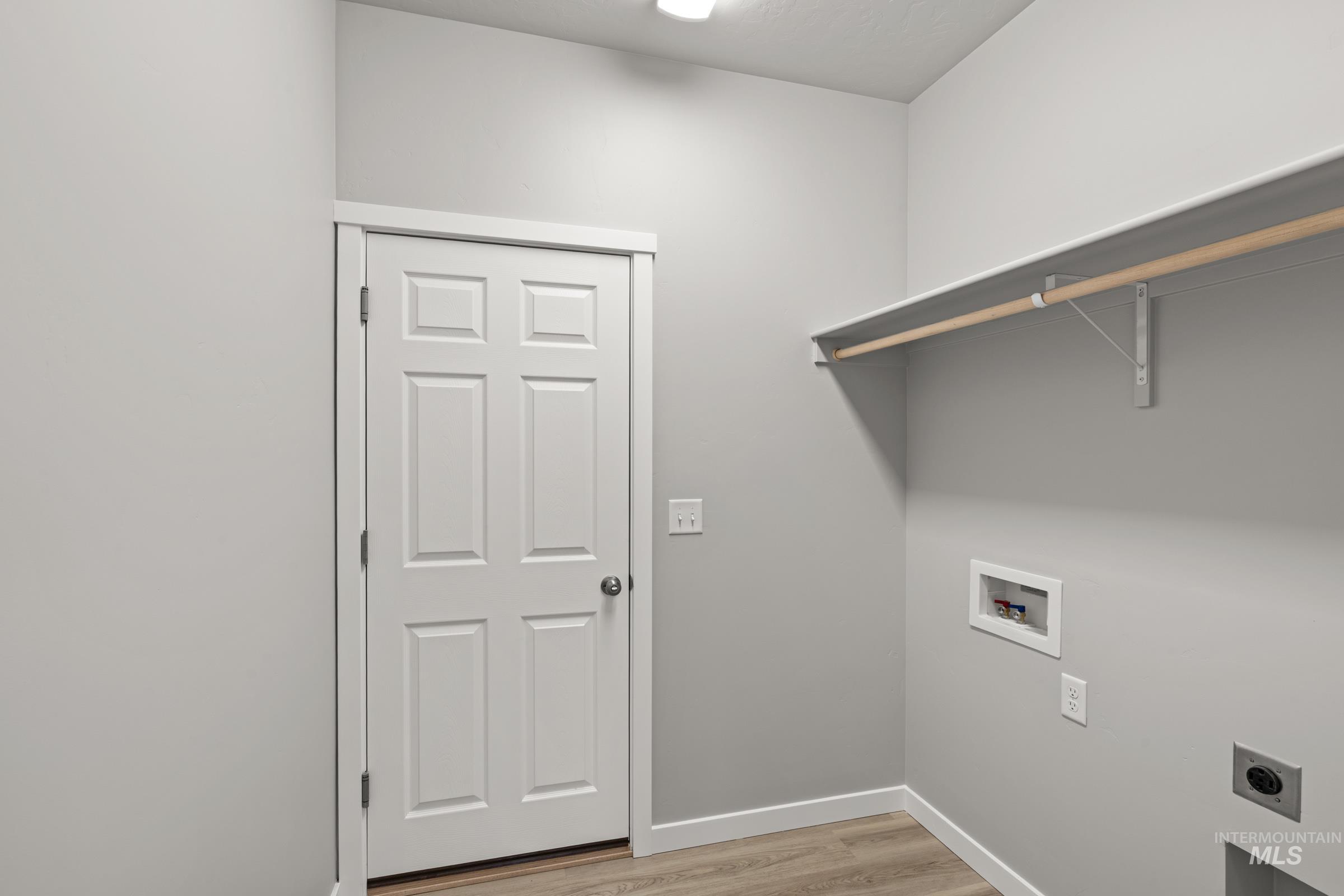 487 Hamlow Avenue Middleton, ID 83644 - Photo 8 of 19 Laundry room with light wood-type flooring, hookup for a washing machine, and hookup for an electric dryer