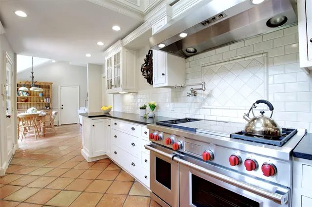 a kitchen with stainless steel appliances a sink stove and cabinets