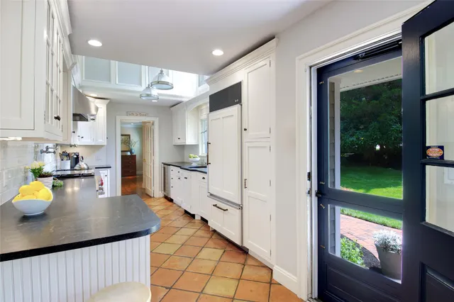 a kitchen with stainless steel appliances granite countertop a refrigerator a sink and a stove