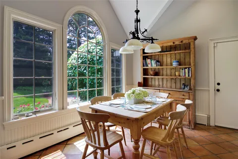a dining room with furniture window and outside view