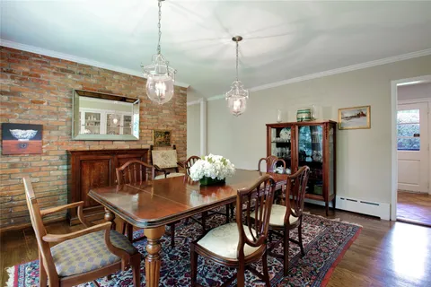 a view of a dining room with furniture wooden floor and chandelier