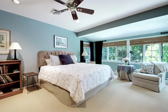 a spacious bedroom with a bed and a large window