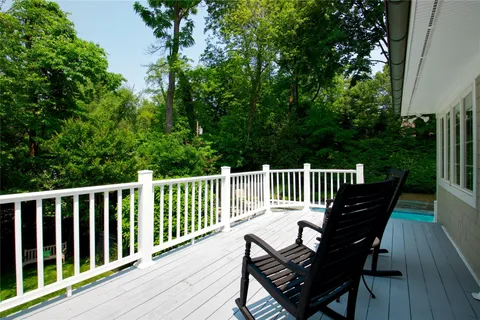 a view of a wooden bench on the roof deck