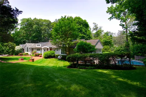 a view of a house with backyard sitting area and garden