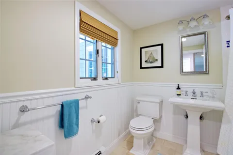 a bathroom with a sink toilet and mirror