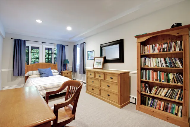 a bedroom with furniture and a book shelf