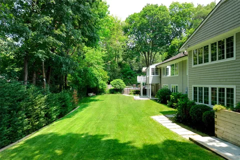 a view of a house with backyard and sitting area