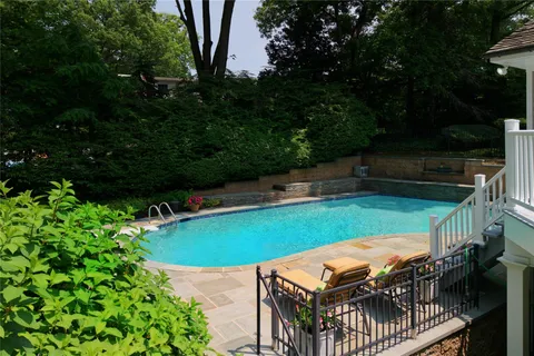 a view of a chairs and table in backyard